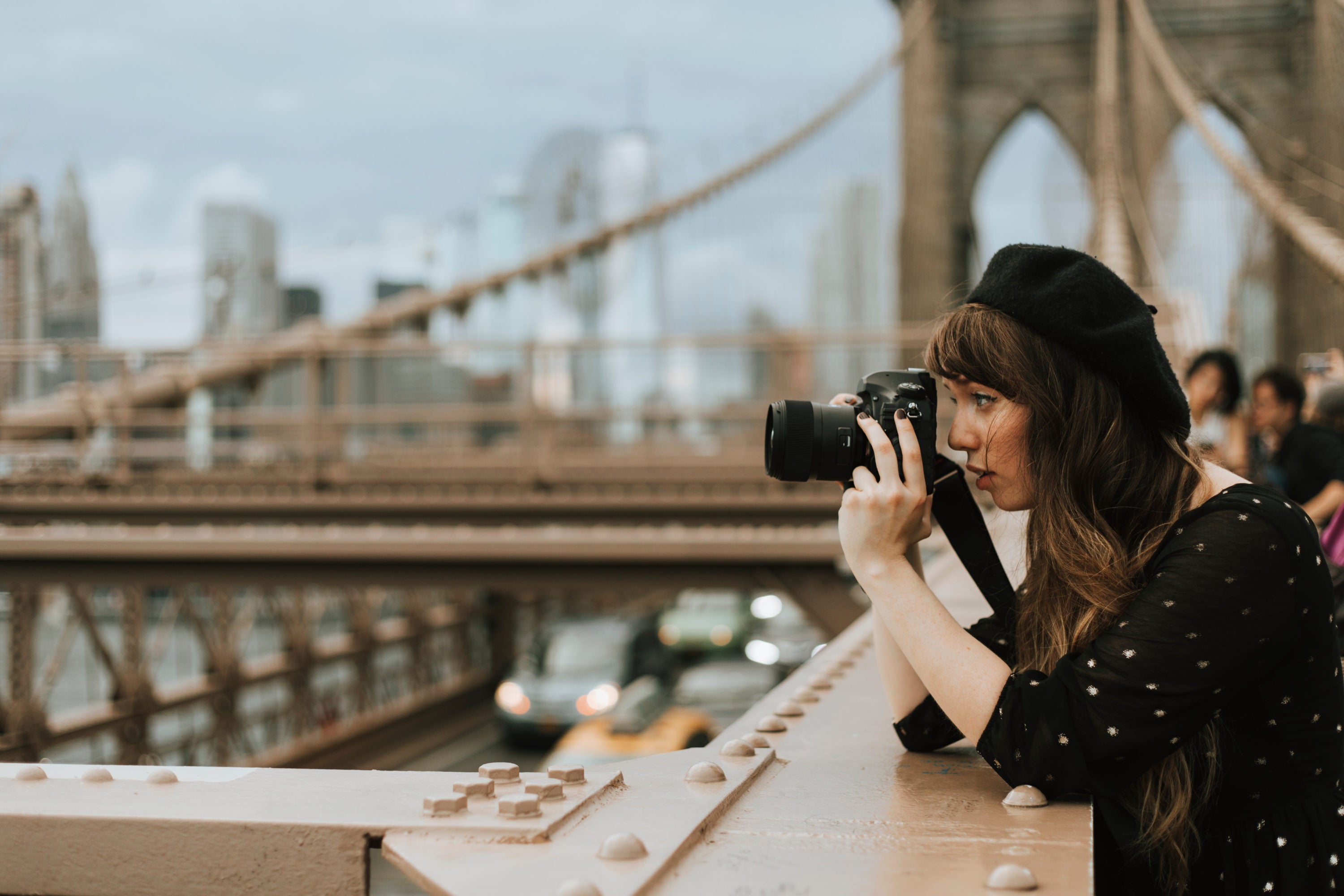 Photographer taking a photo at the Brooklyn Bridge