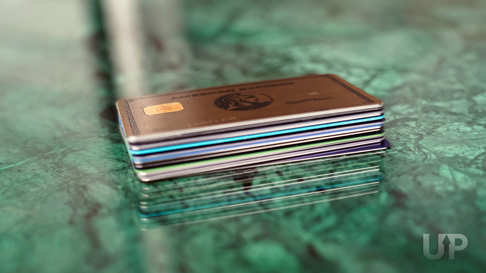 Stack of Credit Cards on Table Upgraded Points LLC