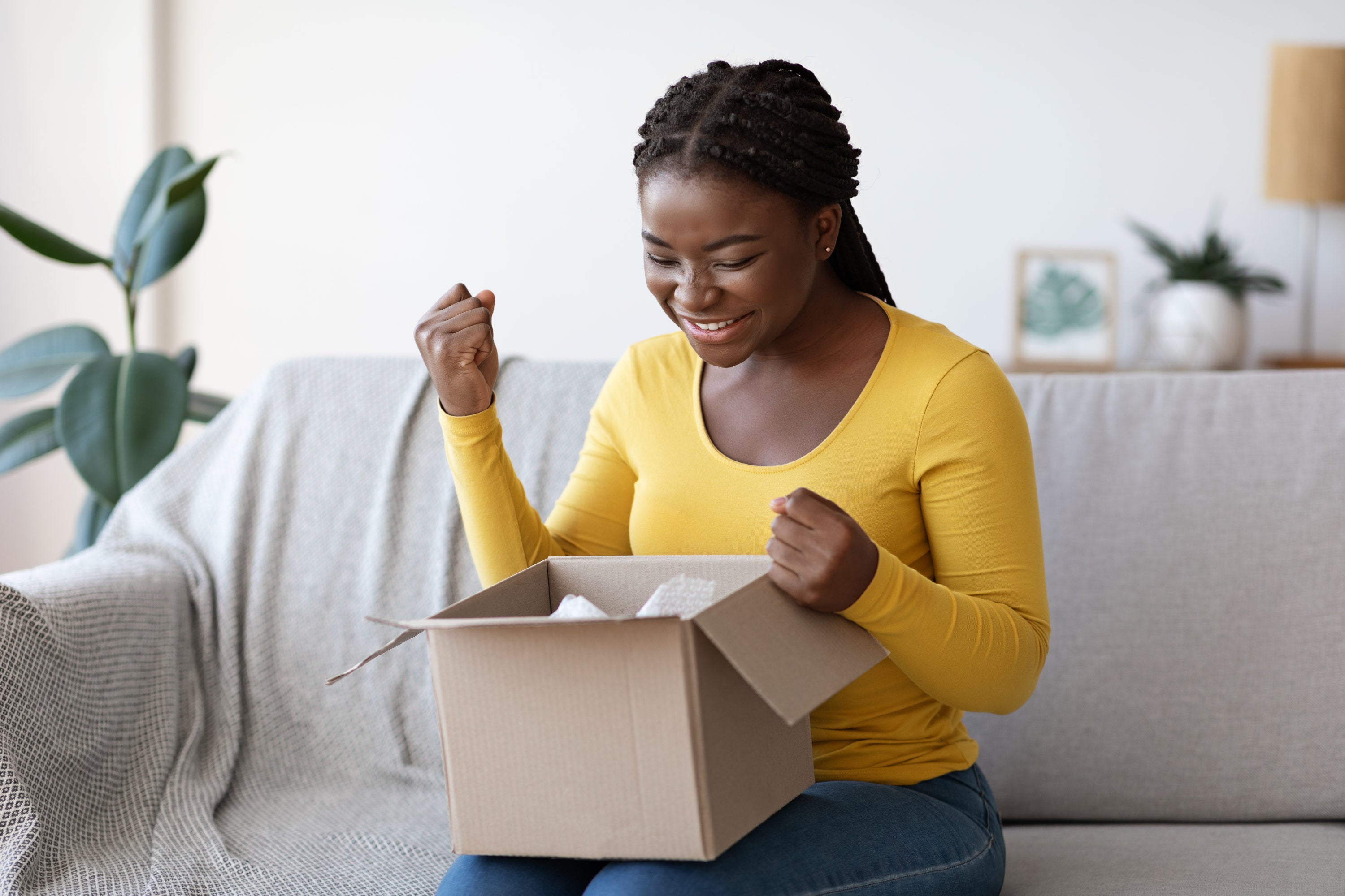 Woman opening box from online shopping