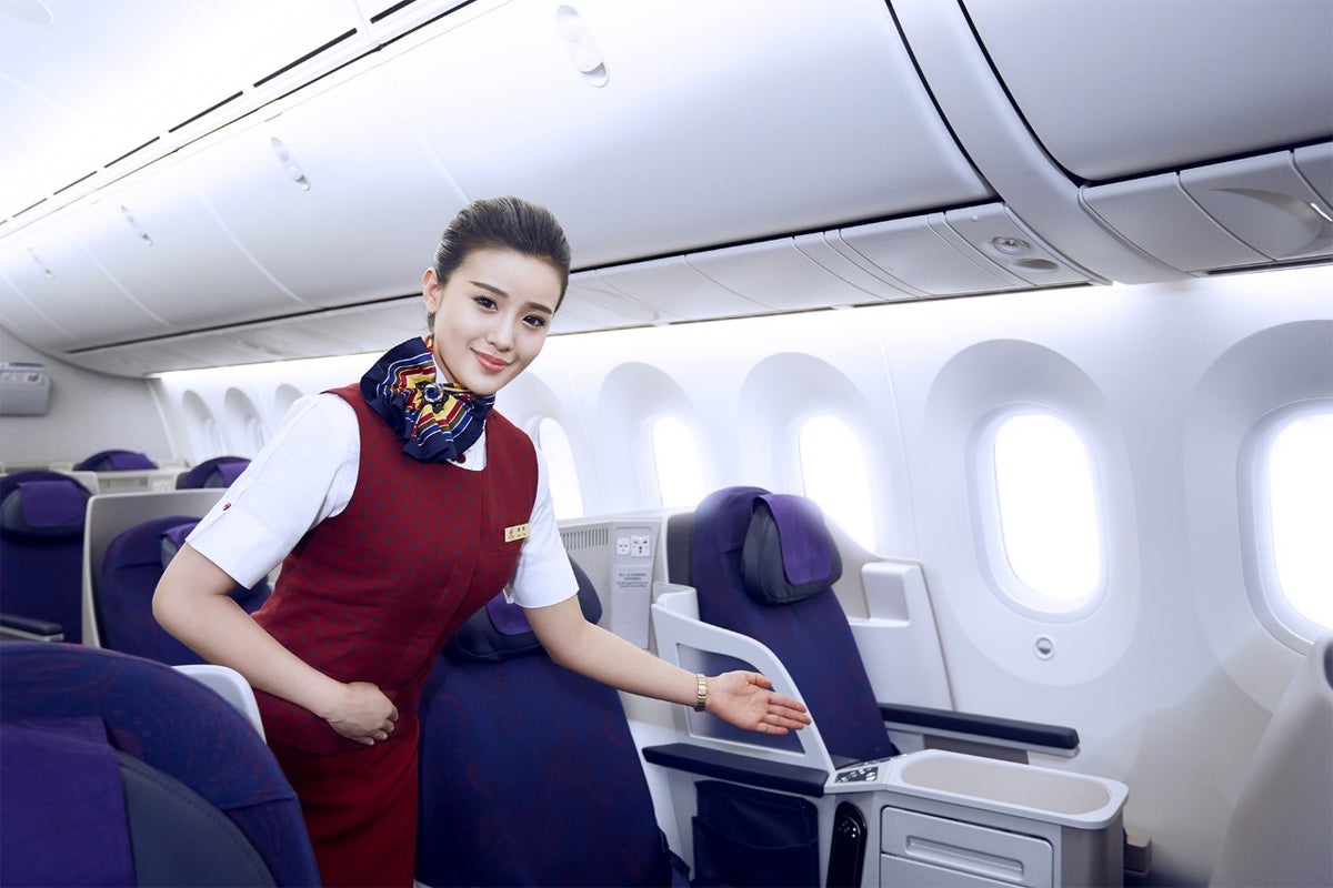 Air China business seat with flight attendant