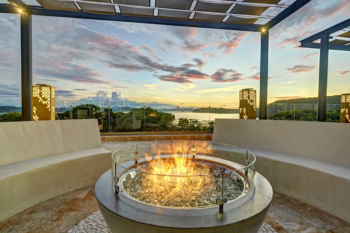 Photo of a fire pit outside on a patio overlooking an ocean view at Planet Hollywood Costa Rica.
