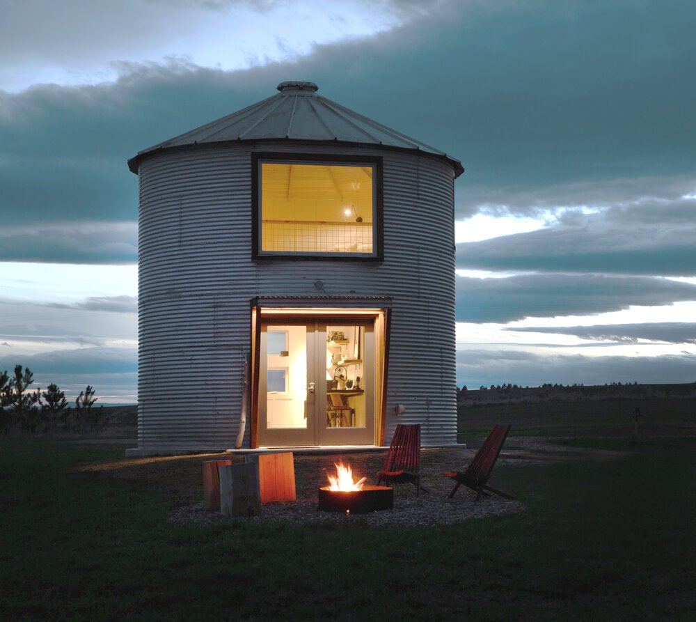 A refurbished silo at Clark Farm Silos with a fire pit outside.