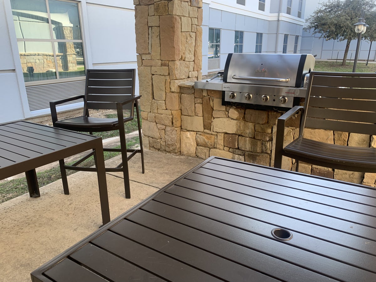 Outdoor seating area with a grill at Homewood Suites Austin Round Rock