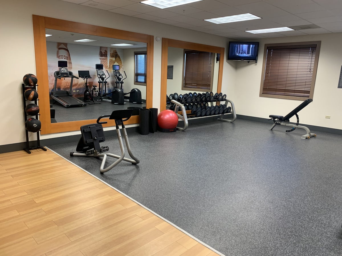 Weights and stretching equipment in the fitness center at Homewood Suites Austin Round Rock