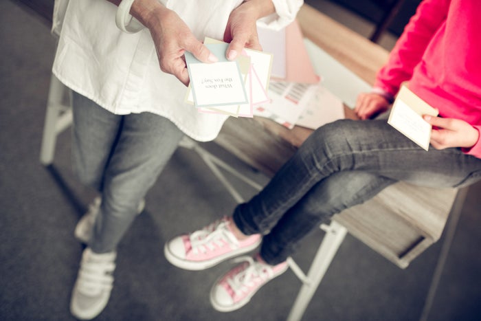 Adult and child looking at flashcards