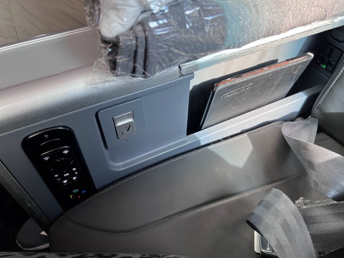 AA Premium Economy seat controls and plugs