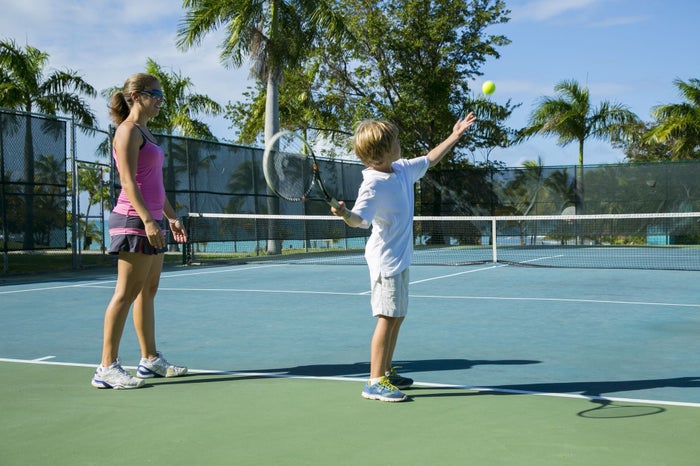 A mom and son play tennis at The Buccaneer Beach and Golf Resort. A mom and son play tennis at The Buccaneer Beach and Golf Resort.