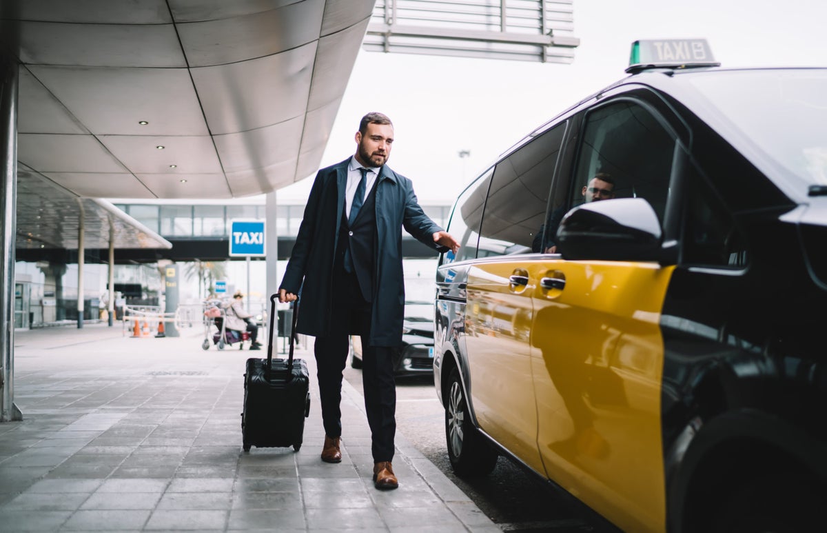 Man getting into a taxi