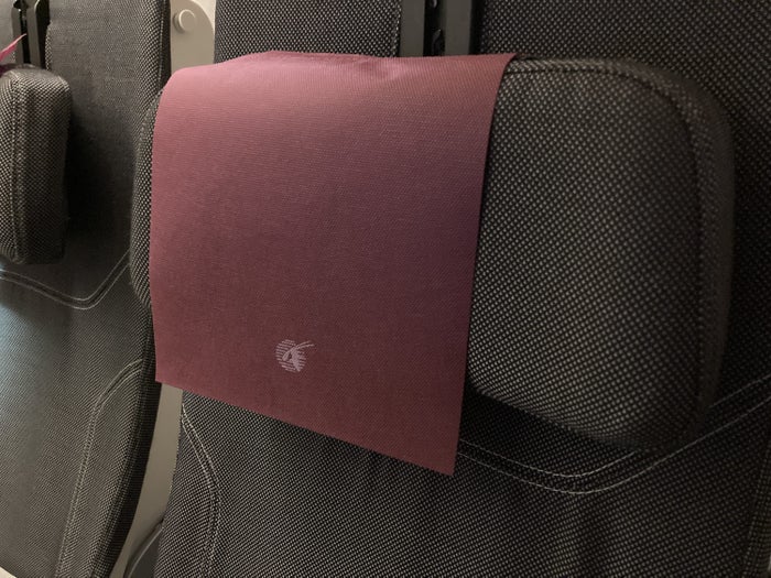 Qatar Airways 777 DOH DFW economy headrest Qatar Airways 777 DOH DFW economy headrest