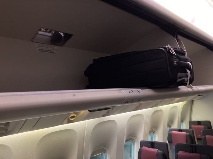 Qatar Airways 777 DOH DFW economy luggage storage Qatar Airways 777 DOH DFW economy luggage storage