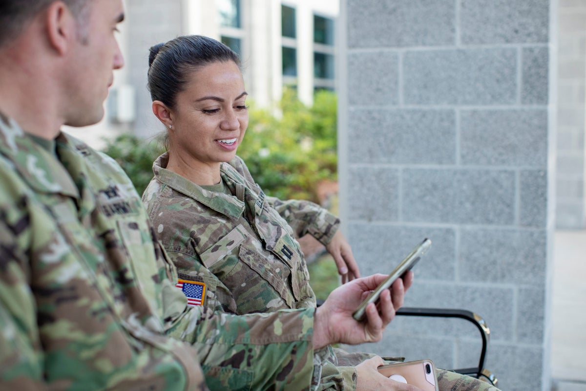 Soldiers looking at a cell phone