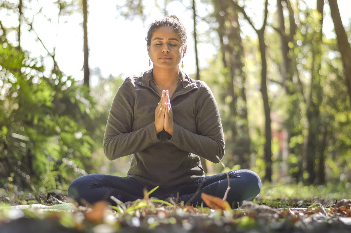 A woman does yoga on a wellness retreat.