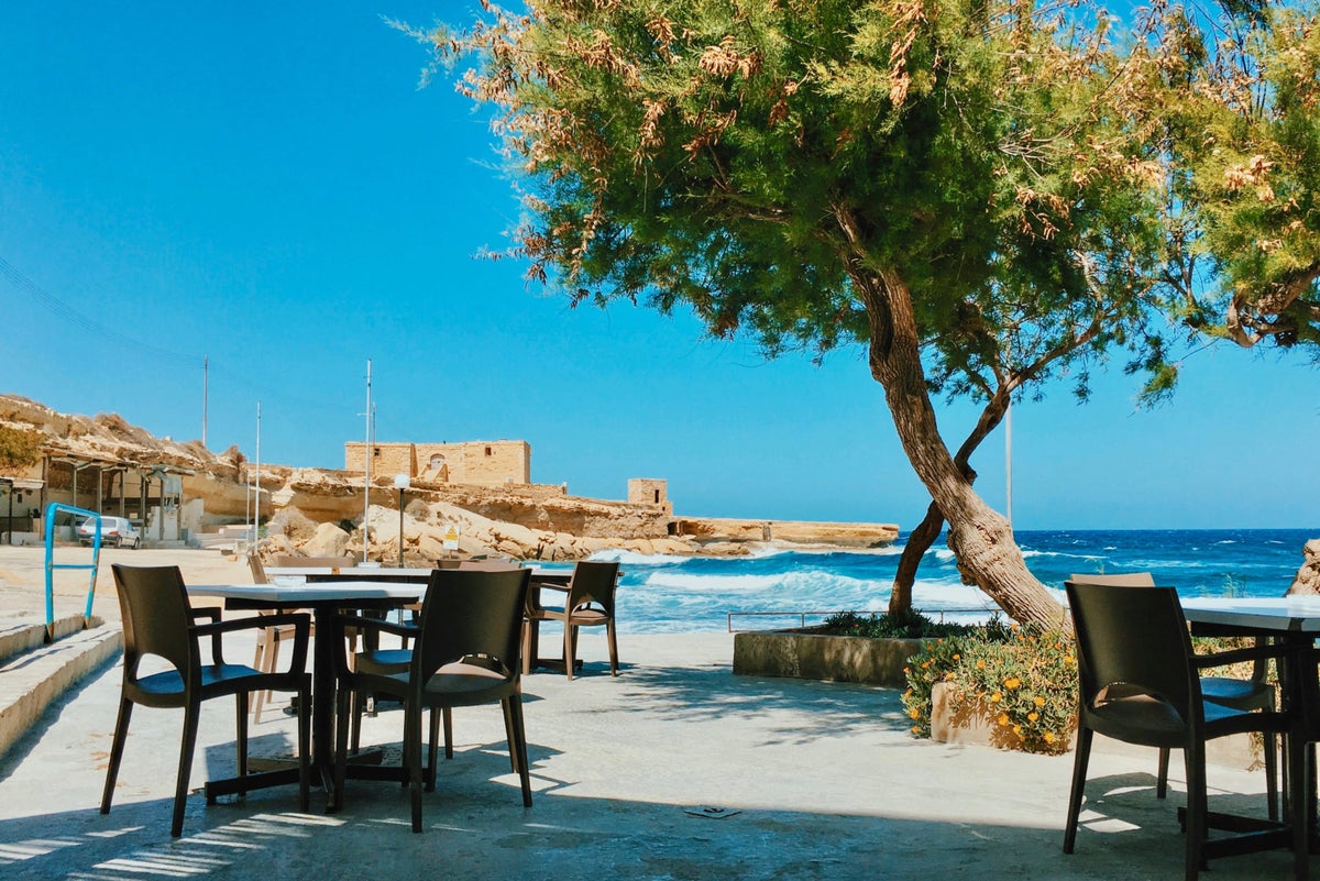 A table and chairs by the sea