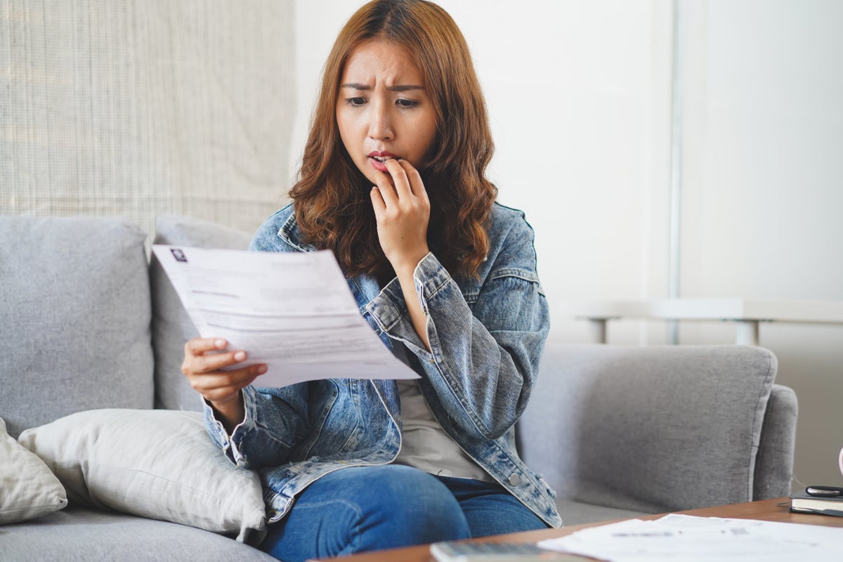Young woman confused about credit report document
