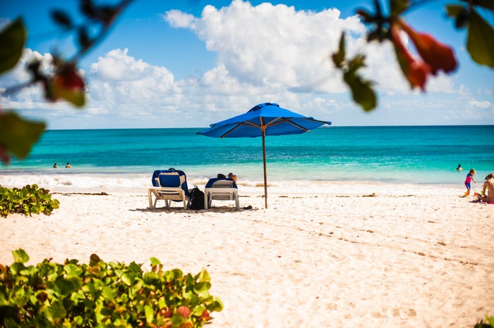 Couples lounge on a Barbados Beach A beautiful beach in Barbados