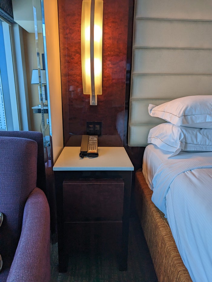 Hilton Grand Vacations Elara Las Vegas bedroom nightstand and chair Hilton Grand Vacations Elara Las Vegas bedroom nightstand and chair