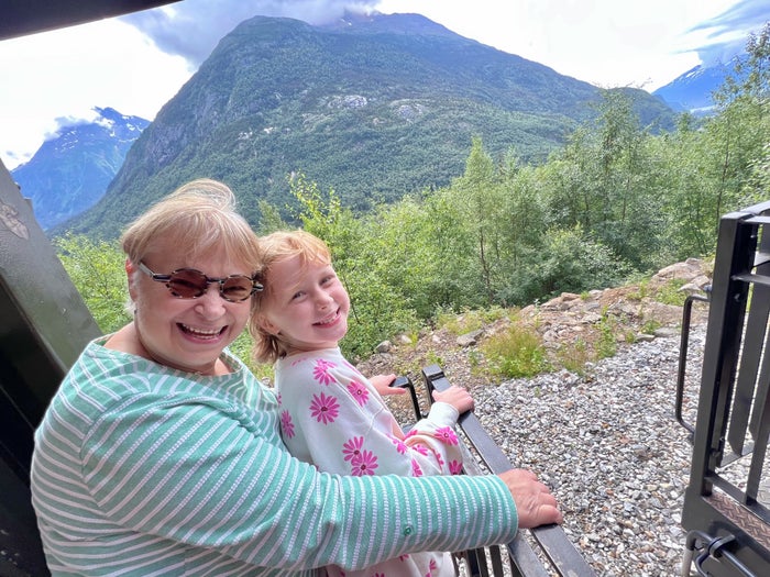 Riding on the White Pass Railroad outside platform in Skagway Alaska Riding on the White Pass Railroad outside platform in Skagway Alaska