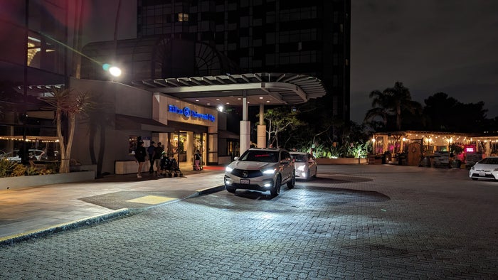 Hilton Los Angeles Universal City location Universal Studios pedestrian walkway Hilton Los Angeles Universal City parking valet area night
