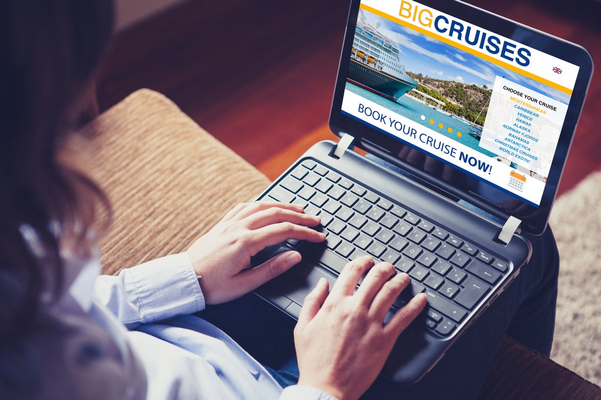 Woman booking cruise travel with laptop 1