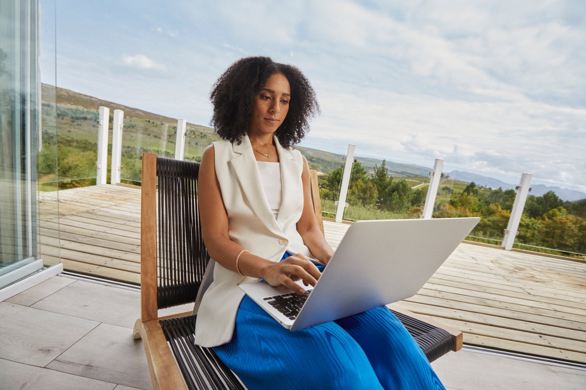 Woman working on laptop on vacation