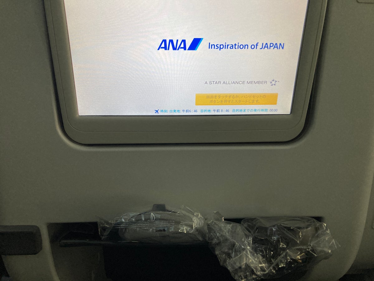 ANA B787 8 business class seat back with screen and slippers