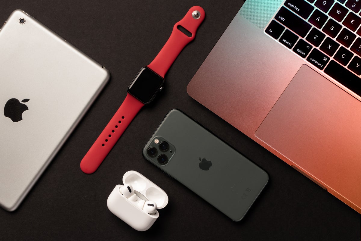 Different Apple products on a grey background