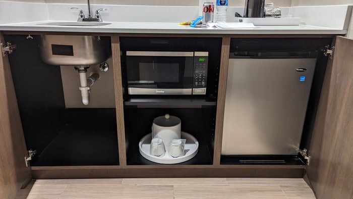 Hampton Inn and Suites Aurora South Denver room entrance mini kitchen with microwave and mini fridge Hampton Inn and Suites Aurora South Denver room entrance mini kitchen with microwave and mini fridge