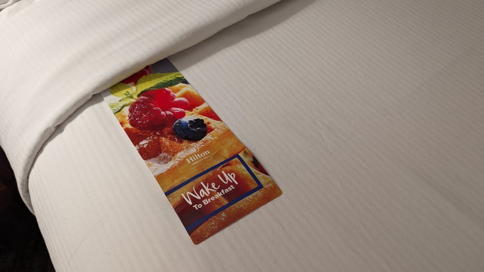 Hilton Pensacola Beach guestroom room service menu on the bed Hilton Pensacola Beach guestroom room service menu on the bed