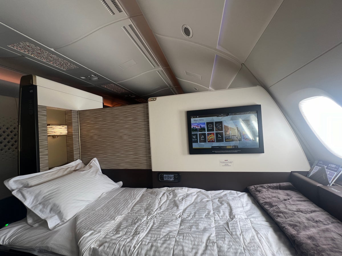 Etihad First Class Apartment bed with duvet cover chair angle