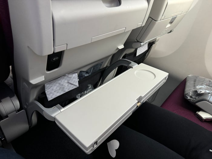 Qatar Airways economy WAW DOH 787 tray table folded Qatar Airways economy WAW DOH 787 tray table folded