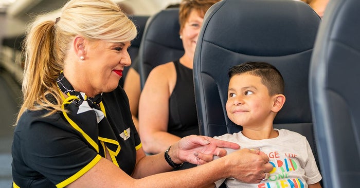 Spirit flight attendant with boy Spirit flight attendant with boy