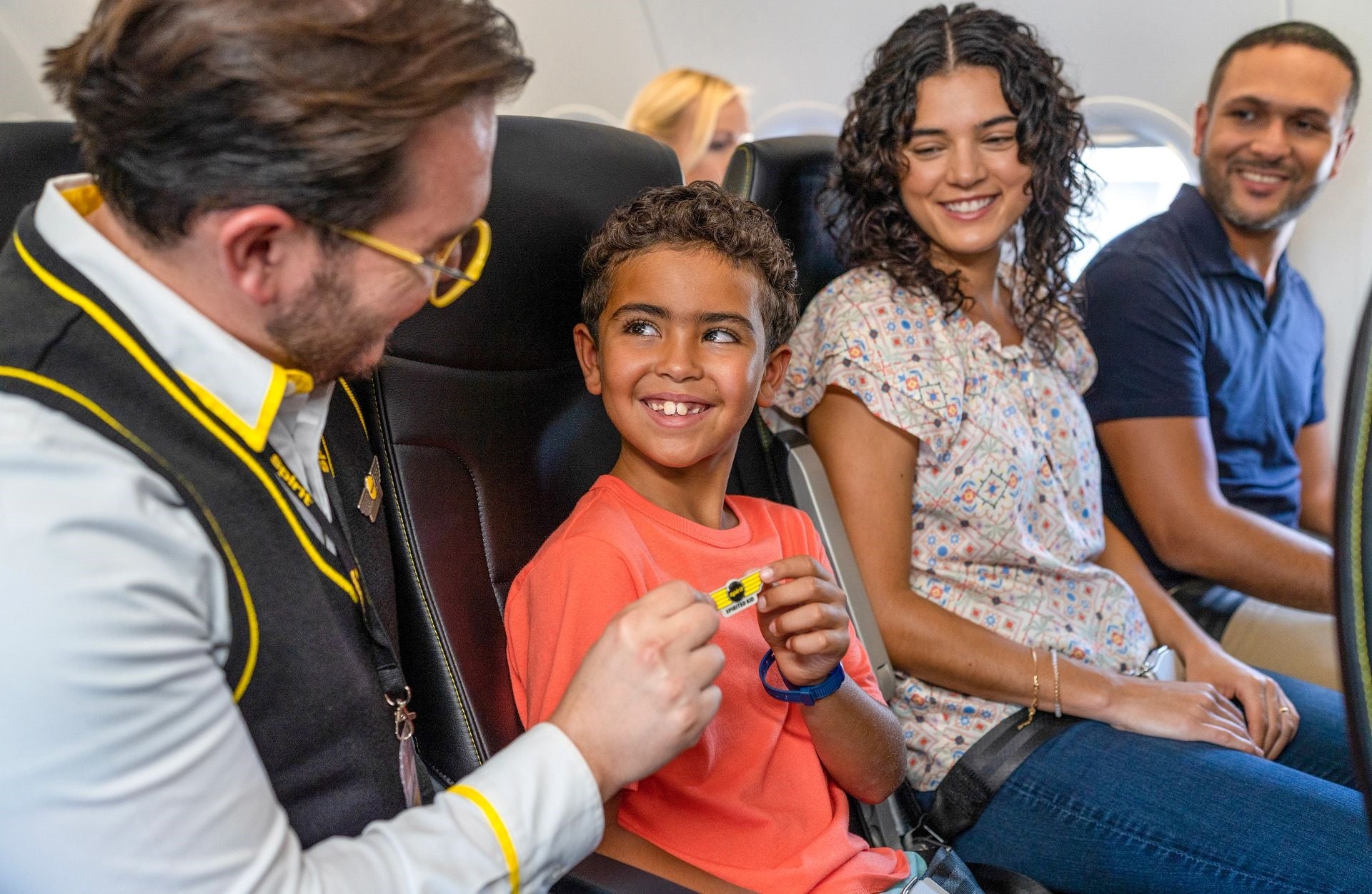 The Ultimate Guide To Flying Spirit Airlines With Kids 2024   Spirit Flight Attendant With Family 