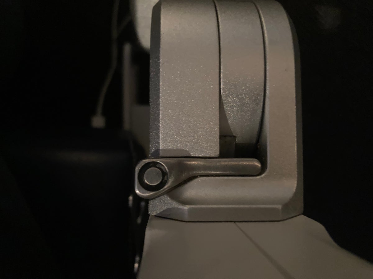 United Boeing 777 200 latch for opening arm with entertainment screen