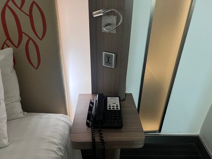 Hilton Garden Inn Bangkok Silom room nightstand and phone Hilton Garden Inn Bangkok Silom room nightstand and phone