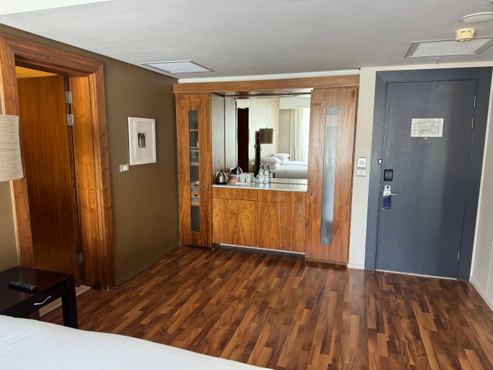 A view of the space between the beds and the closet and counter area shows the closets on either side, drawers and cabinets.