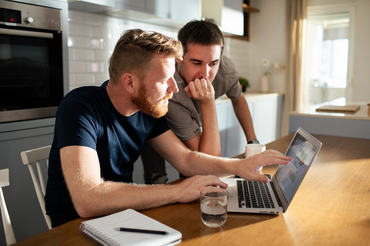 2 men reviewing laptop