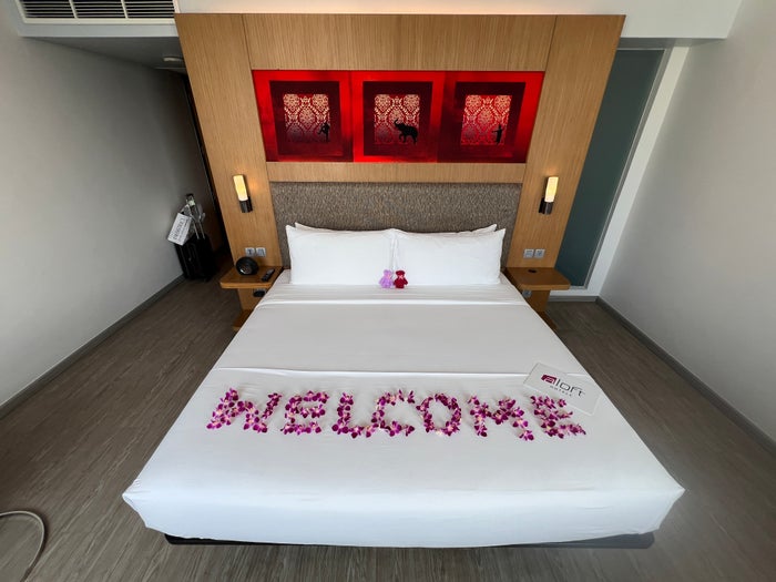 Aloft Bangkok Sukhumvit 11 bed with floral decorations Aloft Bangkok Sukhumvit 11 bed with floral decorations