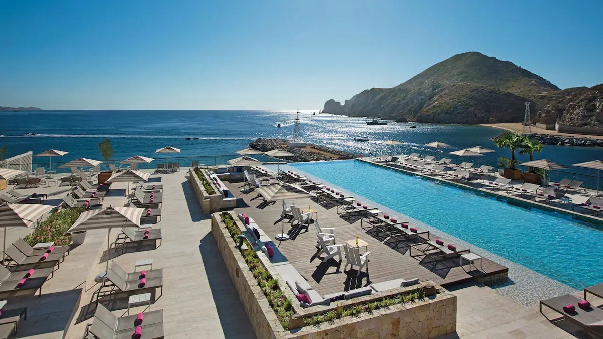 An aerial image of the pool at Breathless Cabo San Lucas Resort & Spa overlooking the ocean.