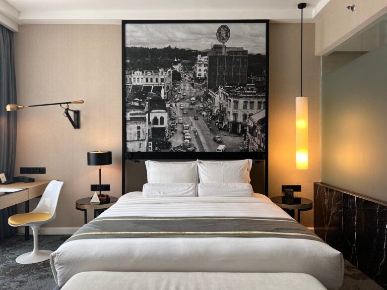 Hotel Stripes Kuala Lumpur Autograph Collection room bed and artwork