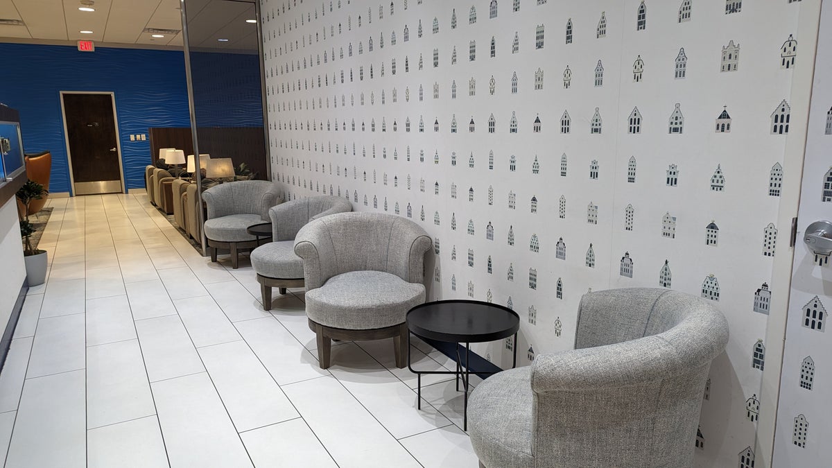 KLM Crown Lounge IAH hallway seating with Delft house wallpaper