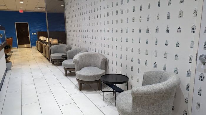 KLM Crown Lounge IAH hallway seating with Delft house wallpaper KLM Crown Lounge IAH hallway seating with Delft house wallpaper