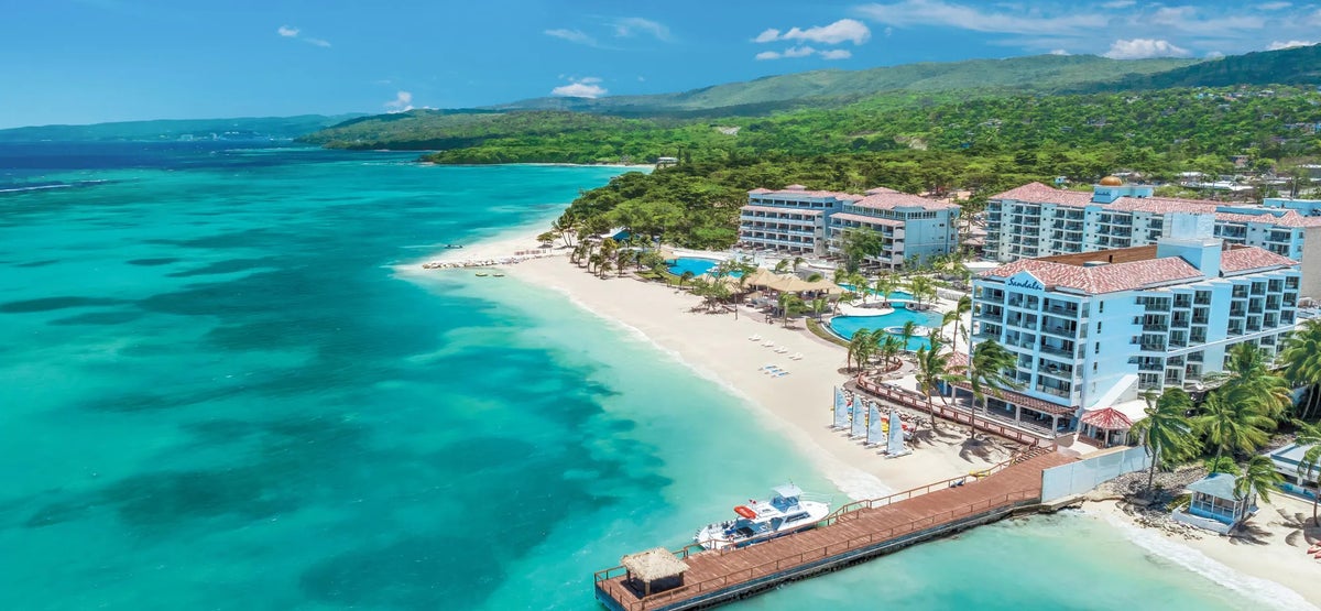 An aerial photo of the hotel, dock, and beach at Sandals Dunns River.