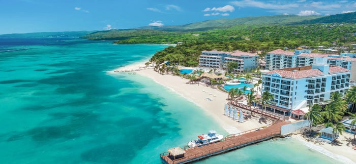 An aerial photo of the hotel, dock, and beach at Sandals Dunns River.