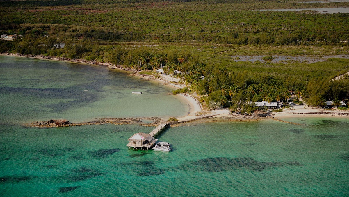 An aerial photo of Small Hope Bay Lodge from the ocean.