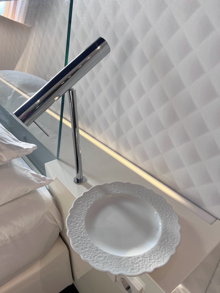 Plate by side of bed at Andaz Amsterdam Plate by side of bed at Andaz Amsterdam