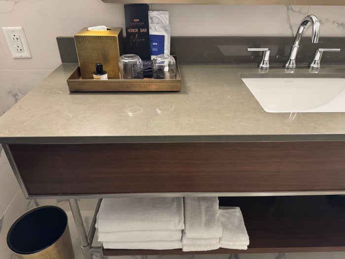 Thompson San Antonio Riverwalk bathroom counter with toiletries and towels