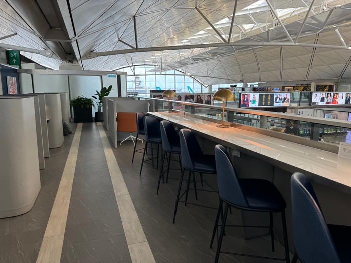 Chase Sapphire Lounge Hong Kong HKG long desk overlooking concourse Chase Sapphire Lounge Hong Kong HKG long desk overlooking concourse