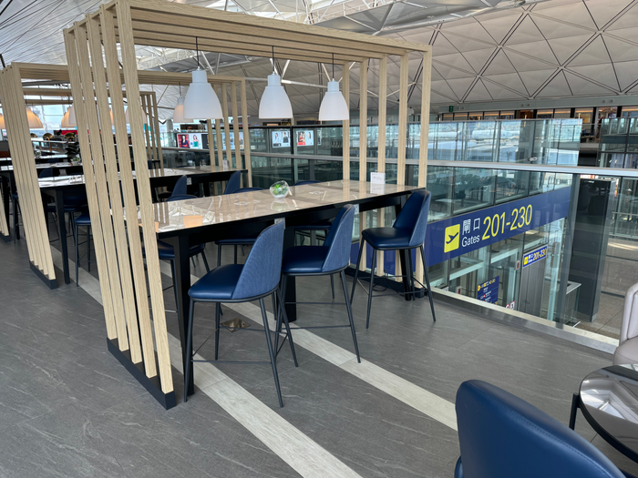 Chase Sapphire Lounge Hong Kong HKG tables overlooking concourse Chase Sapphire Lounge Hong Kong HKG tables overlooking concourse