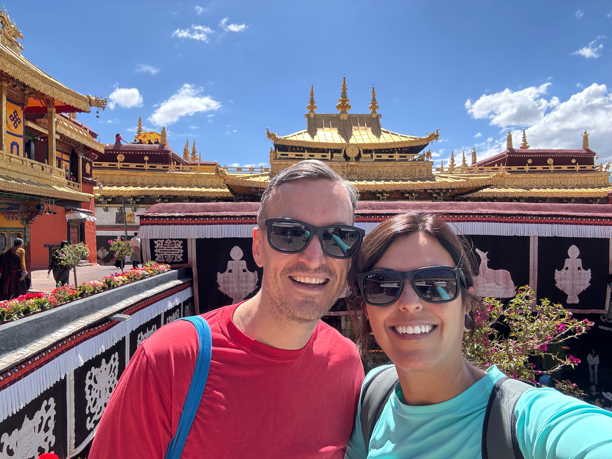 Couple on roof of Jokhang Temple in Lhasa Tibet