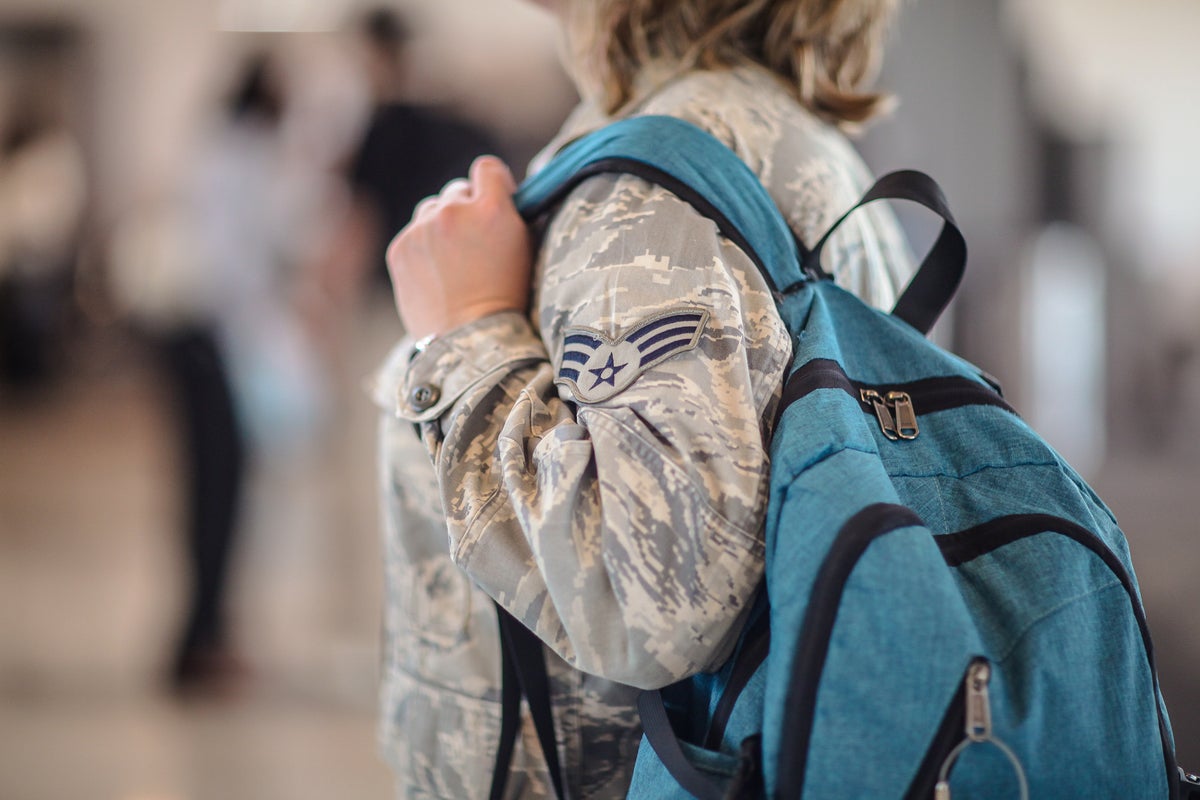 Military woman in airport has luggage in airport